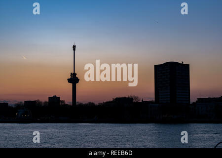 Silhouette of the skyline of Rotterdam at sunset. The mast is an observation tower called `Euromast`, from where you have a wide view of the city. Stock Photo